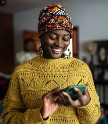 Young woman using the mobile phone at home